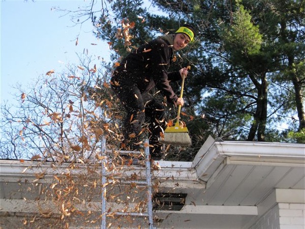 Sweeping leaves off the roof